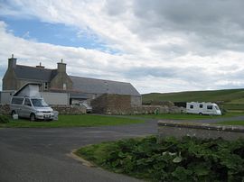 Campsite with hostel in background